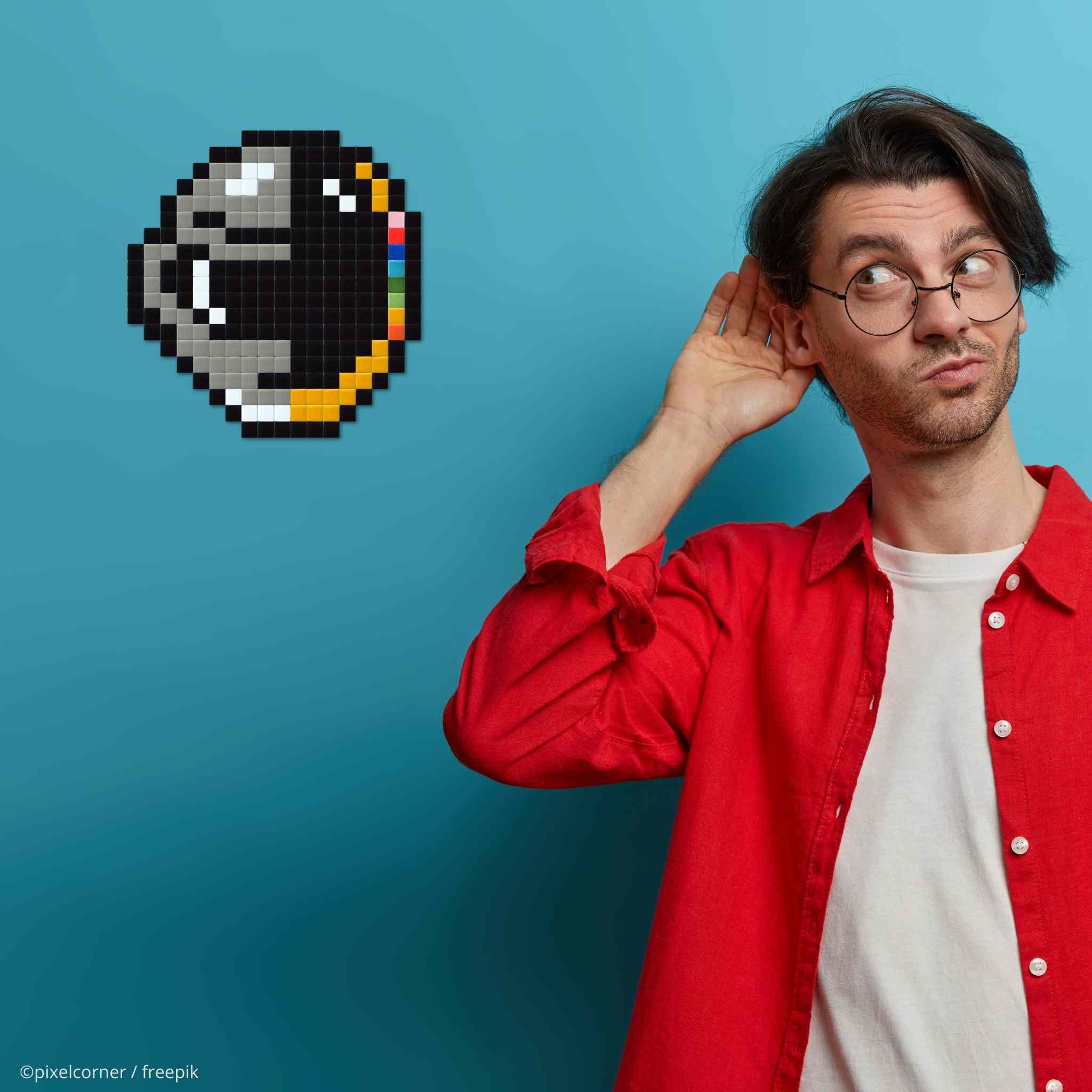 Un homme en chemise rouge tend l'oreille en direction d'un Pixel Art Kit "Paft Dunk" par Pixel Corner - Kits de loisirs créatifs diy ne mosaïque de verre